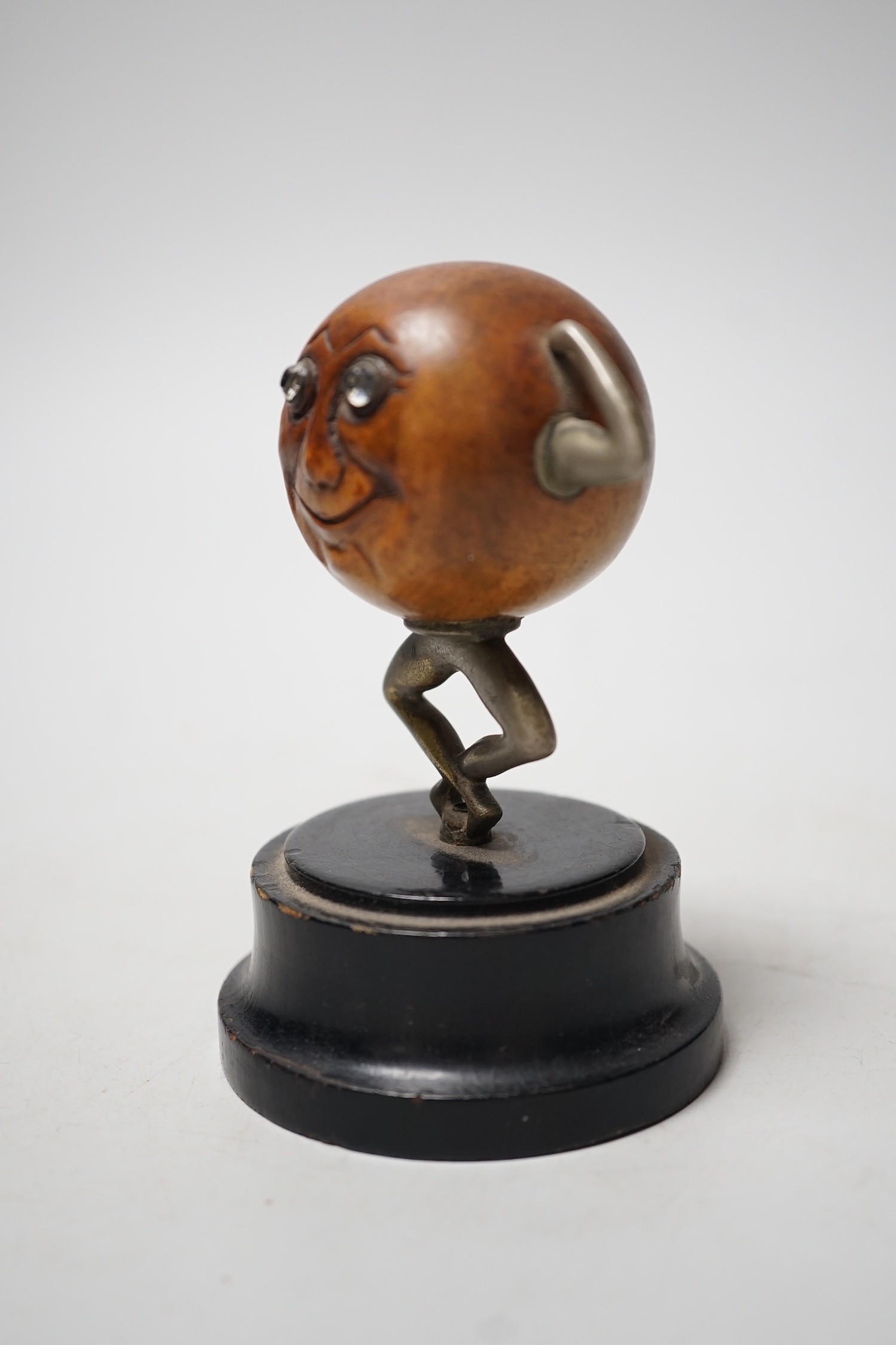 An early 20th century 'Touch Wud' figure, on an ebonised plinth 11cm tall